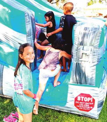(left) Presley Jackson was excited to get on the water bouncy at the Castro County Fair and Harvest Days celebration.