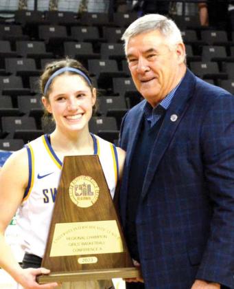 Naz Swiftettes Caroline Myrick, senior, accepted the Regional Championship trophy on behalf of the team.