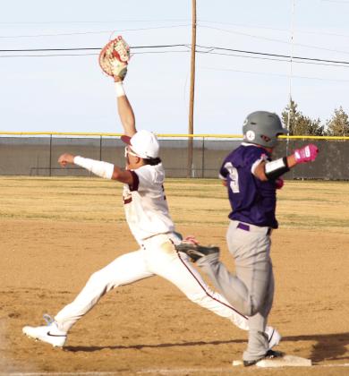 Gustavo Trevino stretches to get the out at 1st