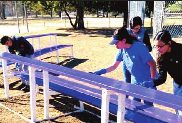 Dimmitt students get into painting during the City Park cleanup.