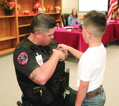 Officer Mendez’s son pins on his badge