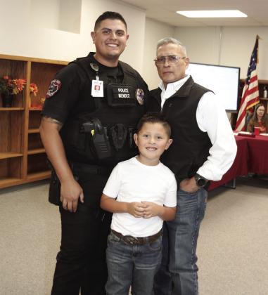 Officer Mendez with his father and son