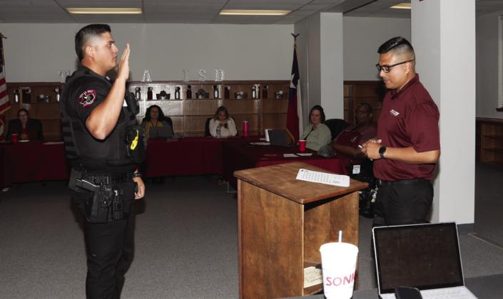 Officer Mendez receives oath of office from Chief Martinez