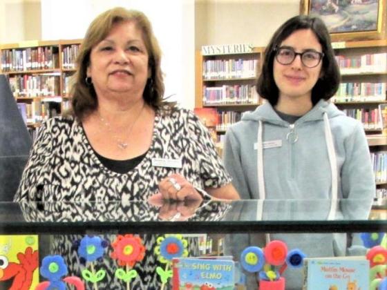 Sulema Oltivero (left), and Paola Alonzo created the display for the months of June and July at Rhoads Memorial Library. Featuring the summer reading program.