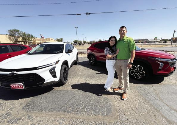 Isaac and Rita Walker of Stevens 5-Star Car &amp;amp; Truck Center stand in front of two new 2026 Chevrolet Trax, the same model of car which will be given away to one Hereford High School senior Friday night during Hereford High School graduation.
