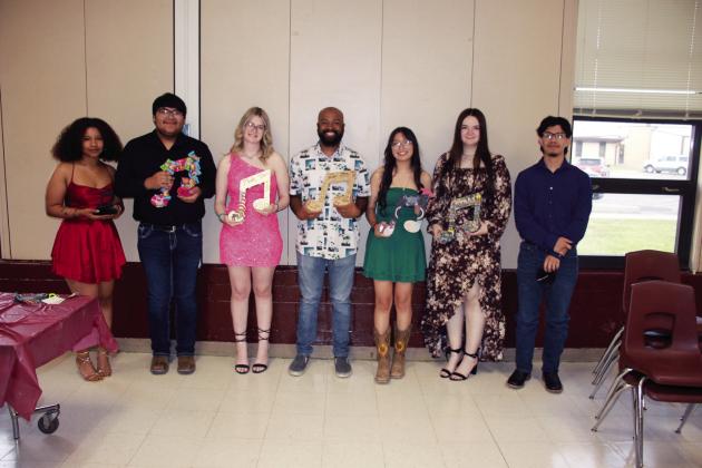 Senior Band members and Mr. Boyd with their musical notes: Jerriah Brookins, Isaiah Hernandez, Maddy Klein, Mr. Boyd, Scarlett Chavez, Avary Wesley, and Vahn Guerrero