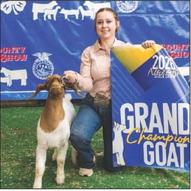 Breed Champion Rylee Scholz and the Grand Champion Goat.