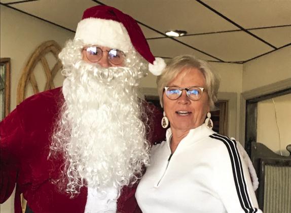 Santa came to the Progressive Study Club Christmas luncheon and brought all the good ladies a gift. Debbi Criswell is asking Santa where her gift is.