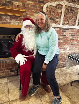 Emily Keese telling Santa her Christmas list.