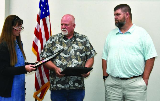 THANKS, GUYS--Outgoing Place 4 Commissioner Mark Collier, who served six years and did not seek re-election, and Place 6 At Large Commissioner Deven Black, who served two years, were recognized with plaques by Mayor Cathy Bunch and thanked for their service on the Hereford City Commission during a special session May 11. (Photos by Jim Steiert)
