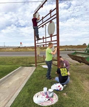 PAINTING ONE DAY--During the Happy One Day 4-H observance on Saturday, October 11, Deaf Smith County 4-Hers worked to make the best better by putting a new coat of paint on the Welcome to Hereford sign on the north side of Hereford. Laying on new paint are 4-Hers Johan and Josef Grotegut, Macy Betzen and Sam Detten. Civic club signs were removed while the painting was in progress and will be put back in place once the project is completed.