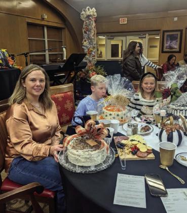 WE’VE GOT THE GOODIES—These kids of all ages seem to have the auction goods cornered as they ponder the deliciousness at the Samaritan Hospice Dessert Auction November 25. The annual event has become a pre-Thanksgiving tradition in Hereford.