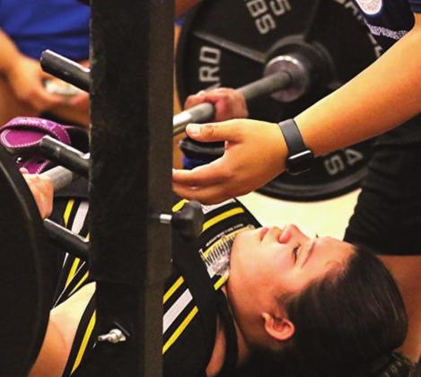 (Photo left) DHS senior Yazmin Barron competing in bench press at the THSWPA state meet where she came in with her personal best. She also earned a place on the All-State Academic Second Team. This was her third trip to the state meet and ended her high school lifting career tying for fifth place.