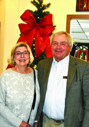 AN ORDINARY CHRISTMAS JOE—Joe Perrin and wife Pam were getting in on the quilt and table piece bidding action at the Festival of Trees auction. (Photo by Jim Steiert)