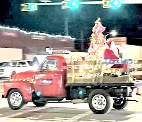 Santa Claus got a ride in the Chamber Parade of Lights in a festive truck.