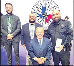 DPD Officer Nicolas Montelongo, accompanied by DPH Police Chief Tony Ramirez and Lt. Ben Elmore, received the Star of Texas Award from Gov. Greg Abbott.