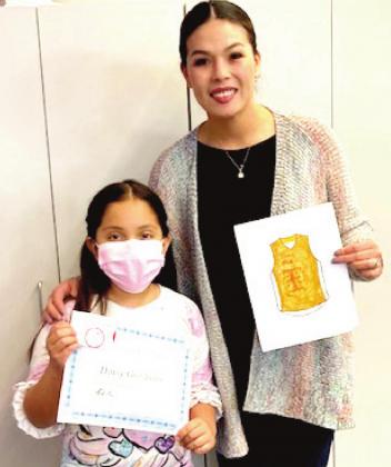 RES student Daisy Gonzales, winner of the girls coloring contest and Principal Maritssa Flores