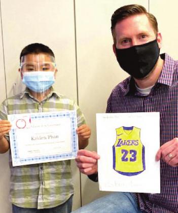 RES student Kaden Phan, winner of the boys coloring contest and Assistant Principal Jason Hamlin.