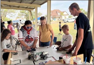 Texas 4-H STEM Ambassador Spencer Acker from Castro County 4-H demonstrates some ins and outs of robotics to youth at the Swisher County Fair. Acker is not only involved in 4-H robotics but also in Texas FIRST competitions.