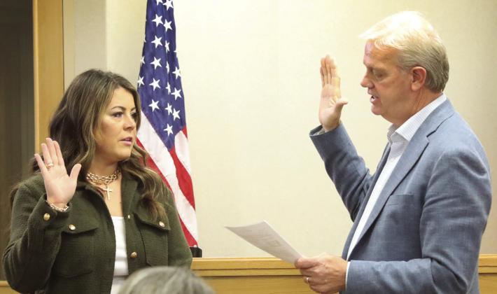 Katie Sims receives her Oath of Office from County Judge Michael Clawson