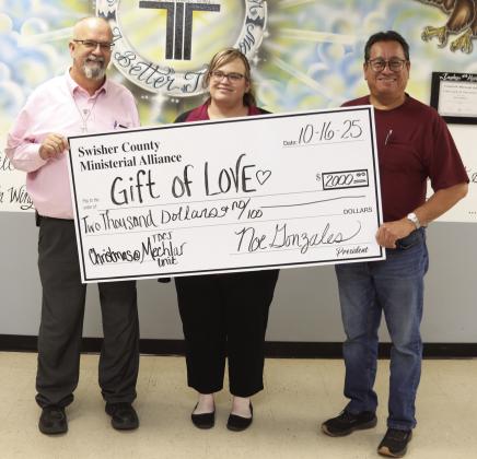 Swisher County Ministerial Alliance presented the TDCJ Mechlar Unit with a Gift of Love to help with Christmas gifts for the residents. Bryan Adams and Monica Brown from the Mechlar Unit accept the donation from Noe Gonzales from the Swisher County Ministerial Alliance.