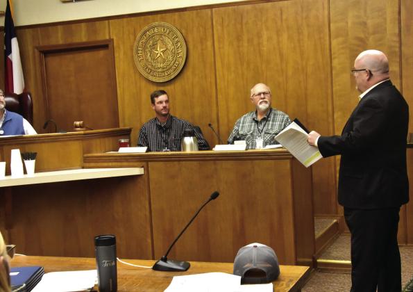 WHAT DID HE SAY?--County Commissioners Kevin Brown and Chris Matthews joined their fellow commissioners in attempting to keep up with what ultra-fast-talking John Merris, right, of Doshier, Pickens and Francis, LLC Certified Public Accountants was saying as he delivered a highly positive presentation of the county’s independent auditor’s report for the year ending September 30, 2025. Fortunately for the commissioners, they had a handout of the report so they could follow along. (Photo by Jim Steiert)