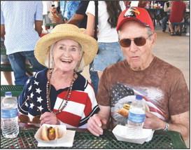 Nan Coneway and Charlie Brown enjoy all American hot dogs for lunch under the pavilion in Dameron Park. (Photos by Jim Steiert)