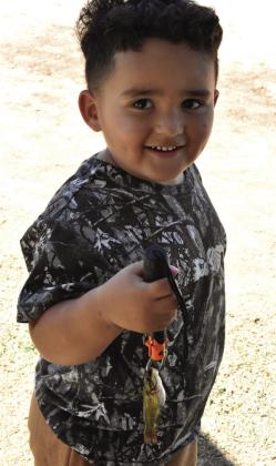 A FISH BY ANY MEASURE—At least I caught something may well have been the thought of this young angler at the Texas Junior angler event Saturday, May 16 at Josserand Aquatic Park Pond. (Photo by Jim Steiert)