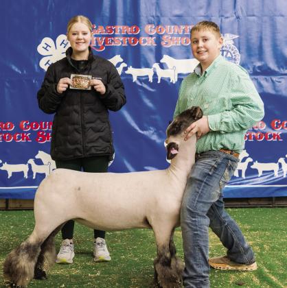 Reed Scholz and his Junior Lamb Showmanship Buckle.