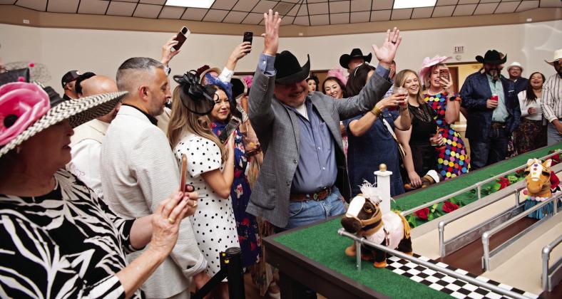 WE WIN THE DERBY!-- Robert de la Cruz of First Financial Bank celebrates power pony Lady Penny crossing the finish line first in the seventh annual running of the electronic eohippus Kentucky Derby at the Hereford Senior Citizens Center Gala May 2. (Photo Courtesy of Pam McNutt)