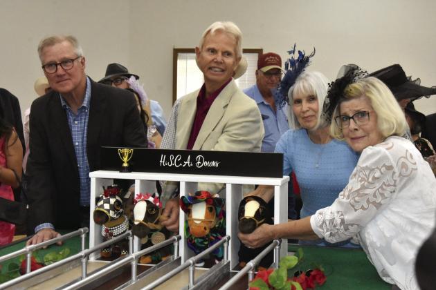 STARTING GATE TENSION--(Above, right) Seemingly a few nerves were showing at the starting gate in this preliminary heat of the big run for the roses at the seventh annual Kentucky Derby Gala at the Hereford Senior Citizens Center on May 2. Looking to position their powered ponies just-so are from left, Scott Hall, Bill Youngsma, Cindy Black, and Pam Perrin. Big overall winner was Lady Penny, rolled by First Financial Bank.