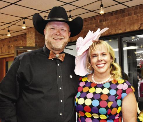 BEST DRESSED, BEST BOW TIE—It was all in the family for Justin and Candice Smith as they both came away with wardrobe wins in the seventh annual Hereford Senior Citizens Center Kentucky Derby on May 2. Justin sported an unusual leather bow tie for Best Bow Tie Honors and Candice Smith showed her usual elegance in a colorful dress fit for Derby Day that won her the Best Dressed Woman title. (Photos by Jim Steiert)