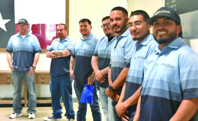 WAITING IN THE WINGS--Members of the outside crew from West Texas Rural Telephone Cooperative await duties of delivering door prizes to lucky winners at the 71st annual membership meeting March 24. (Photo by Jim Steiert)