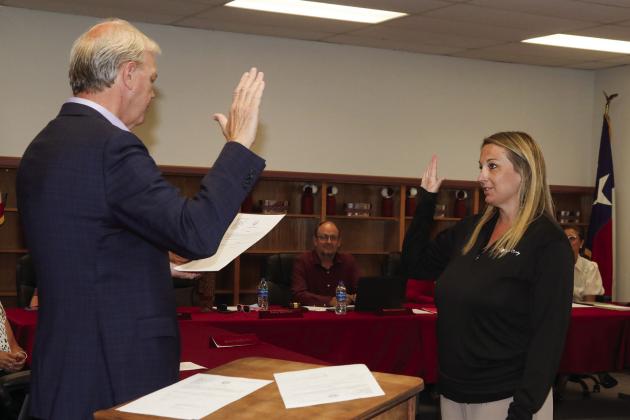 Swisher County Judge Michael Clawson administers the oath of office to Tulia ISD School Board Trustee Kacy Quinton