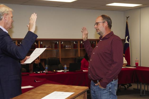 Swisher County Judge Michael Clawson administers the oath of office to Tulia ISD School Board Trustee Clint Mahannah