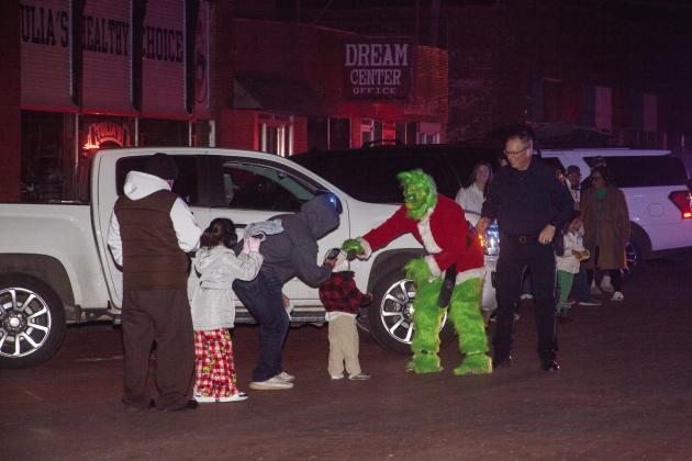 The Grinch temporarily escaped from the police to steal candy from the children at the Lighted Parade