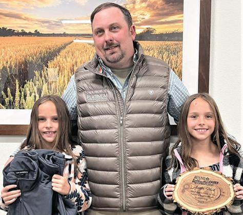 Nazareth Ag teacher and FFA Advisor Austin Heck, shown with daughters Izzy and Gabby, received the AgTexas Ag Youth Leader of Year award. Heck is one of three nominees to be awarded the recognition in Texas this year. Heck has led students to multiple state wins in ag contests and state single teacher chapter awards as well having students go on to universities to compete nationally in ag competitions.