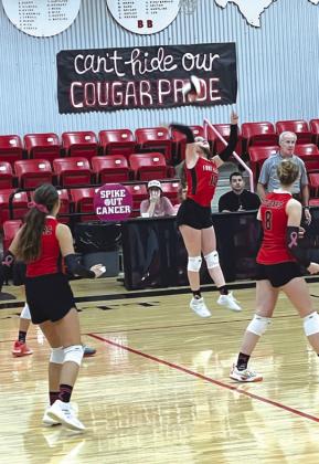 JV Lady Cougar, Kaylee Lee, spikes the ball.