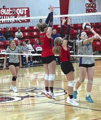 JV Lady Cougars, Mikayleigh Ferguson and Reagan Gaines, block the ball in their game against Wildorado.