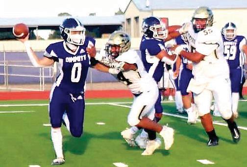 The Bobcats quarterback scrambles to get the pass off as the Memphis defense presses in. (Dimmitt Sports Media photo)