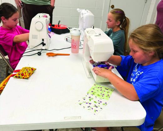 To get ready for the nation's 250th birthday, Castro Coun - ty 4-H made American Flag T-shirts and coasters June 14. The group learned about using fusible to make our flag, sewing on a T-shirt and using a sewing machine to not stitch both sides, strip piecing to make a coaster and us - ing fusible to add stars. (Courtesy photos)