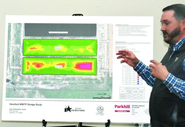ALL SLUDGED UP--Troy Luedeker, Parkhill engineer, uses large display placards that illustrate the sludge-impaired nature of lagoons at the present-day Hereford Wastewater Treatment Plant during the March 2 City Commission meeting. Luedeker explained the city would incur huge expense clearing out and disposing of the sludge, only to incur the same problem again down the road. (Photo by Jim Steiert