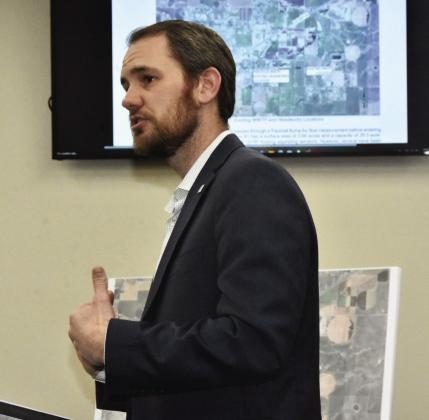 GIVING TREATMENT OPTIONS--Daniel Albus, a Parkhill water treatment expert, outlines water treatment plan options for city commissioners at their March 2 regular meeting. (Photo by Jim Steiert)