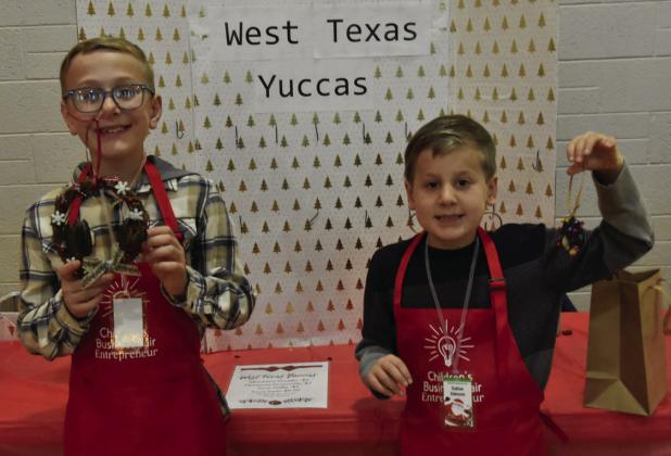 YUCCA HOLIDAY—Nolan and Colton Johnson, ages 10 and 7, took a clever approach in harvesting the fruit of yucca plants and turning it into clever Christmas decorations at the West Texas Yucca Décor booth, where they sold out early.