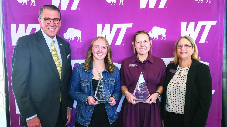 West Texas A&amp;amp;M University President Walter V. Wendler, left, and Pamp Young, right, assistant vice president for human resources, celebrate the WT student employees of the year: Landry Posey, second from left, undergraduate student employee of the year, and Jessica Kenedy, second from right, graduate assistant of the year.