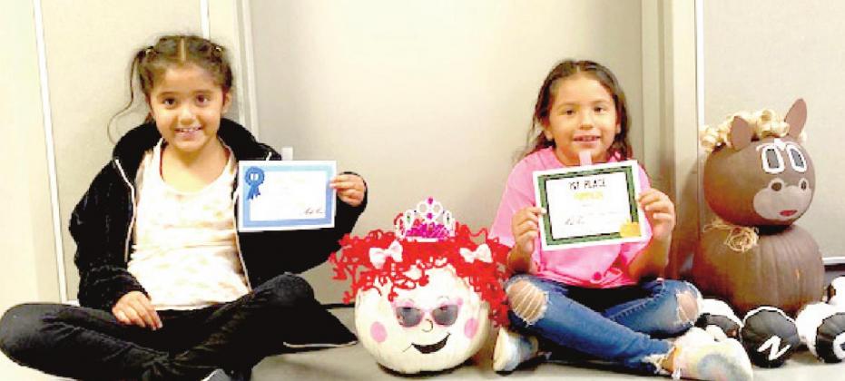 (Photo Right) RES Pumpkin Contest Winners - First Grade: Camie Rueda, 1st place; Allison Ontiveros, 2nd place.