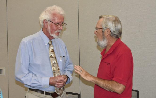 DID YOU REALLY?--Joe D. Rogers, Registered Professional Archeologist, visits with Dean Sanders of Levelland following his presentation to the Texas Association of Healthcare Volunteers during their District 1 meeting in Hereford on September 18. He fascinated the gathering with takes on historic finds. (Photo by Jim Steiert)