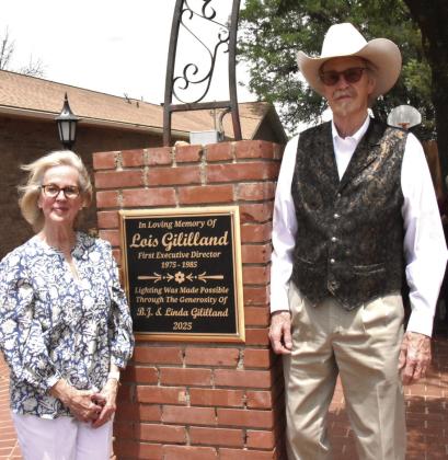 THANKS FOR SUPPORT--Linda and B.J. Gililland stand next to the plaque on the west side of the Ruby K. Sears Memorial Garden during a ceremony hosted by the Deaf Smith Historical Society honoring their support for the Deaf Smith County Museum. They were recognized for funding new electrical wiring and lighting at the Sears Garden. They are long-time supporters of the Deaf Smithsonian. .(Photo by Jim Steiert)