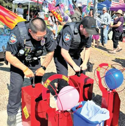 DPD officers fill balloons at the Harvest Days celebration.