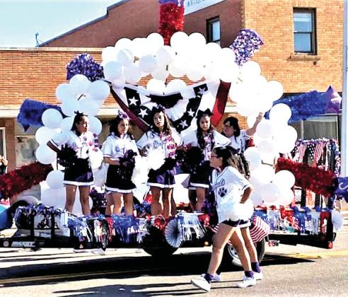 Day Parade – Cheerleaders adorned the parade with spirit and bal- loons.